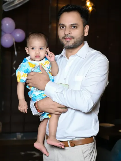 A simple, clean portrait of a father holding his baby boy.