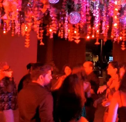 The room is bathed in red light, creating a romantic and energetic atmosphere.