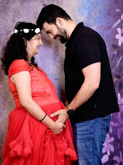 An intimate forehead-to-forehead pose that beautifully captures the love and connection between the expecting parents.