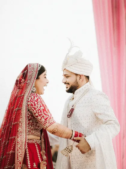 A playful and happy interaction between the bride and groom. Her makeup is designed to last through all the smiles, laughter, and happy tears of the day.