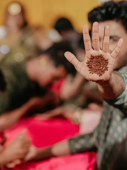 The groom shows off his simple yet meaningful Mehendi design, a modern trend that I love incorporating for a fun couple moment.