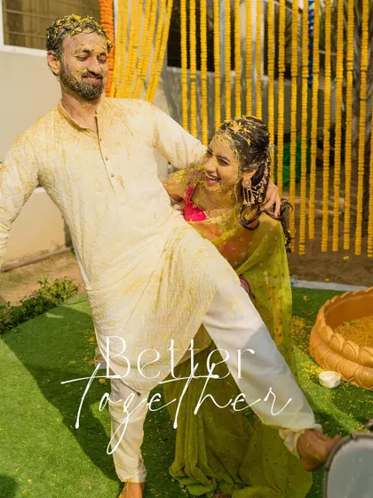 A playful moment captured after the Haldi ceremony, with the couple covered in turmeric and smiling together.