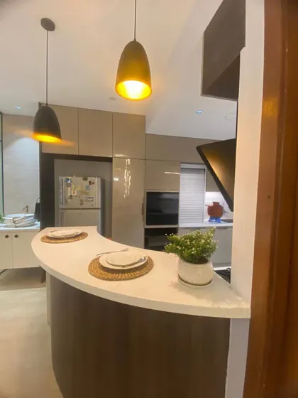 A final look at the kitchen and breakfast bar, a perfect spot for morning coffee. The design seamlessly integrates with the adjoining living space.
