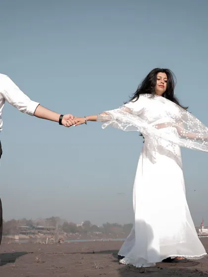 Capturing a candid moment of love and connection during a pre-wedding shoot on the sandy banks of the Yamuna.