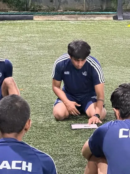 Coaches discussing a session plan. Meticulous planning goes into every training session to ensure it is effective and engaging.