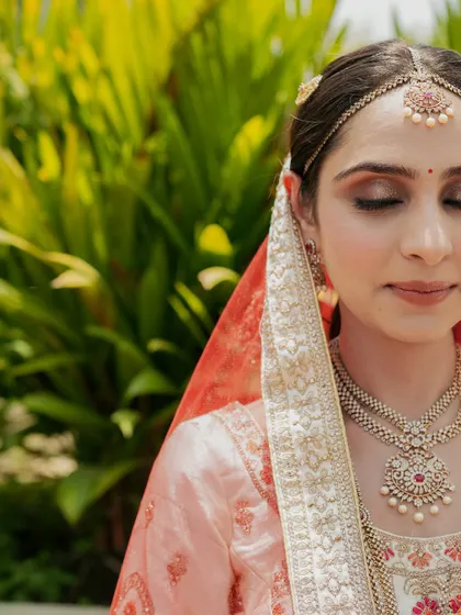 A serene bridal portrait, with the bride's eyes closed, capturing a moment of peace and beauty.