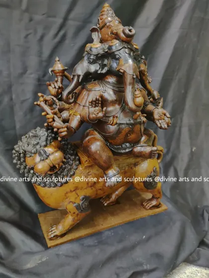 A side profile of the complex Heramba Ganapati wax model. This five-headed form of Ganesha riding a lion requires immense focus to sculpt, ensuring all ten arms and their symbolic items are correctly placed.