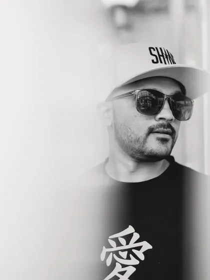 A black and white portrait, ready to turn up the volume and light up the night. It's all about the music and the vibe.