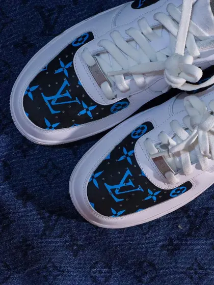 A top-down view of the custom Louis Vuitton print AF1s. The pattern extends to the toe box for a complete, all-over luxury look.