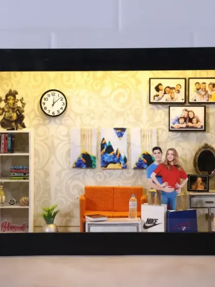 A miniature living room in a box. This theme box includes a couple's cutout, tiny furniture, photo frames on the wall, and even a Ganesha idol for blessings.