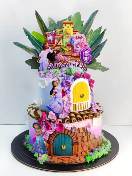 A vibrant Encanto-themed cake focusing on the character Isabella and her floral powers. The cake is decorated with beautiful, hand-piped flowers.