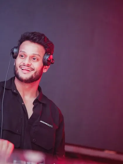 A shot of me in the zone. This is the smile you see when the mix is perfect and the crowd is roaring. This isn't just a job, it's my passion.