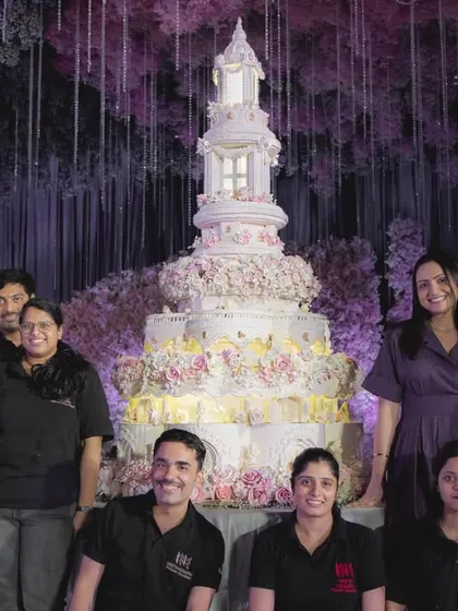 My amazing team and I standing proudly with our colossal 8-foot wedding cake. This creation was a true labor of love, and it wouldn't have been possible without their dedication and passion for perfection.