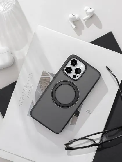 A clean and minimalist flatlay for a Fusegear iPhone case. The monochromatic color scheme with black, white, and grey elements creates a sophisticated and modern look, perfect for a tech accessory.