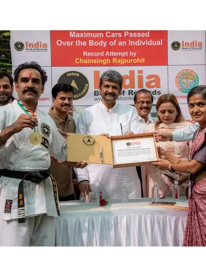Another moment of recognition, being presented with the medal and certificate for the record of maximum cars passed over the body.