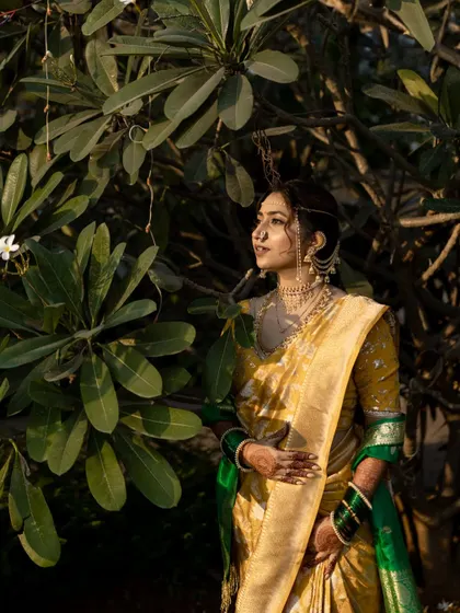 A serene portrait of the bride amidst lush greenery, looking thoughtful and elegant.