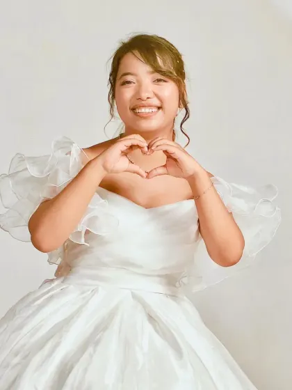 A joyful shot featuring our white ball gown. The off-the-shoulder neckline perfectly frames the face for beautiful close-up portraits.