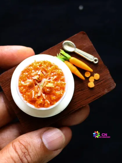 Another angle of the beautiful carrot halwa miniature, held in hand to show its scale.