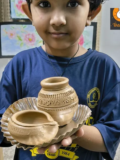 The finished product! This young potter is so proud of the pot and diya he created on the wheel. Taking home a functional piece of art is an incredibly rewarding experience.