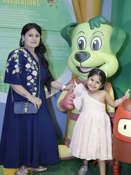 A mother and daughter pose with our Tinga Dojo statue. These are the precious moments we love to help create.