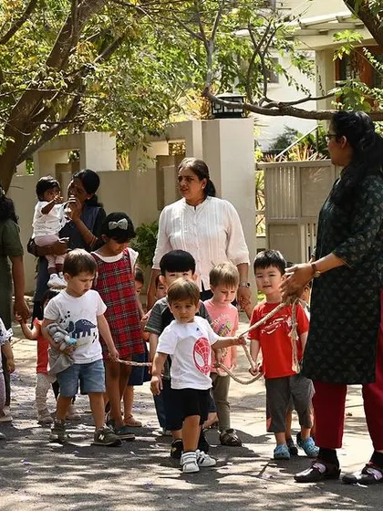 The whole group on a nature walk, a regular activity that promotes physical health and observational skills.
