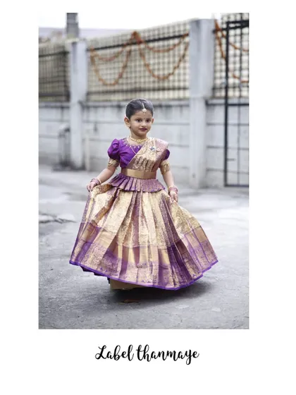A beautiful purple and gold pattu pavadai. The pleats are designed to give the skirt a lovely flair when she walks and twirls.