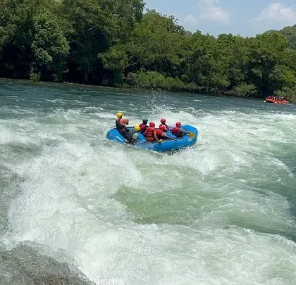 Riding the waves on the Kali River, this shot captures the dynamic movement of the raft and the beautiful, lush scenery of Dandeli.