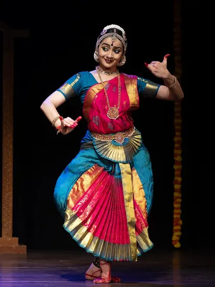 A joyful, energetic pose from the Kanasu festival, capturing the spirit of a lively pure dance piece.
