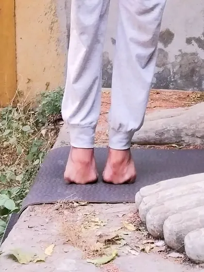 A close-up view of the folded-toe balance, an intense practice for strengthening the feet and ankles. This level of detail is important for developing proprioception and control.