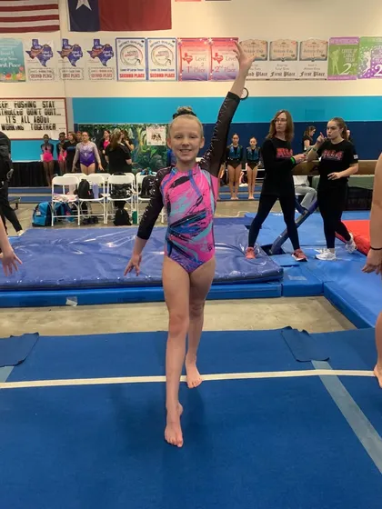 This Gold athlete is all smiles on the competition floor after qualifying for regionals at her state meet.