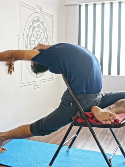 A beautiful demonstration of a supported backbend on a chair, opening the heart and shoulders with grace and stability.