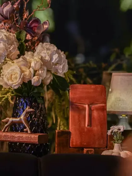 A mix of textures and materials, with white hydrangeas, dark magnolias, and unique terracotta decor. This composition shows our flair for combining different elements into a harmonious whole.