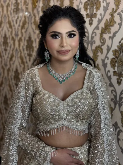 A close-up portrait of this engagement look. We paired a classic black smokey eye with a neutral lip, a timeless combination that works beautifully with her emerald and diamond jewellery.