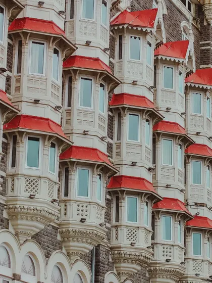 A close-up of the repeating bay windows of the Taj Mahal Palace, a beautiful architectural pattern.