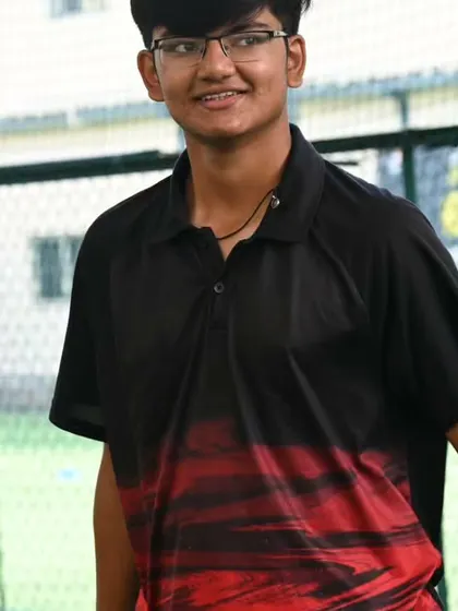 A young adult player shares a light moment during a training session. We foster a friendly and encouraging atmosphere where players can relax and enjoy their game.