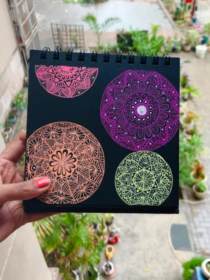Four mini mandalas in different colors and patterns on a single sheet. This shows the variety of designs I can create, even in a small format.