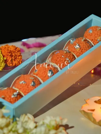 A closer look at the Motichoor Laddoo candles from my Mithai collection. Each one is detailed with silver 'vark' made of wax, arranged neatly in a slim box, making for a unique and tempting festive favor.