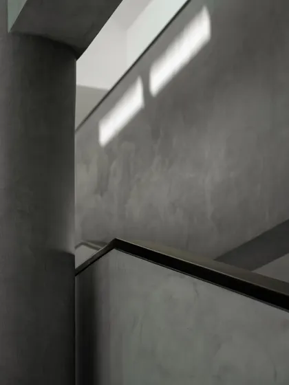 Interior views of the gallery-like spaces, where concrete columns and walls create a neutral yet powerful backdrop for art. The play of light from skylights and windows animates the surfaces.