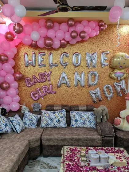 The full 'Welcome Baby and Mom' setup, featuring a mix of pink and metallic balloons, foil letters, and a large teddy bear to complete the scene.
