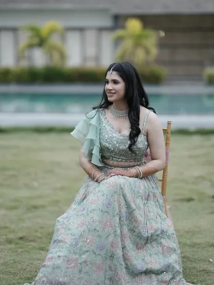 A beautiful shot by the pool. The soft, romantic makeup and hairstyle create a look that is both modern and timeless.