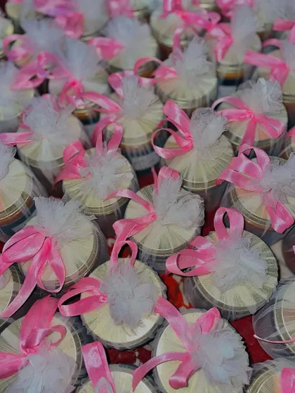 A sea of pink ribbons on our custom wedding candles, ready to be dispatched for a celebration.