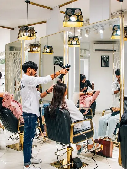 A glimpse of our salon in action. We have created a vibrant and professional space where our talented stylists work their magic. You can see our team attending to multiple clients, ensuring everyone gets the best service.
