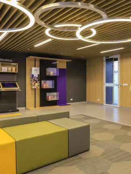 An interactive zone in the Oriflame office with digital terminals and modular seating. We created a dynamic and colorful space for training, presentations, and collaborative work.
