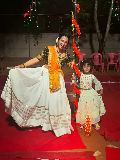 Sharing a sweet moment with a young participant at a Garba night. My events are family-friendly, and I make sure even the little ones feel included in the fun.