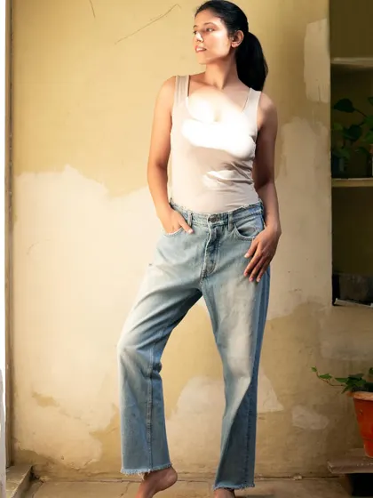 A confident, standing pose in a casual outfit, demonstrating a simple yet strong presence.