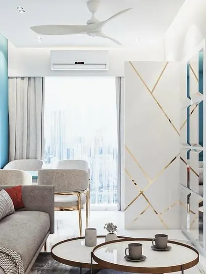 This shot highlights the custom partition with gold inlay, which subtly divides the entryway from the living area without blocking light. It's a functional piece of art that adds a touch of glamour and defines the different zones within the open-plan space.