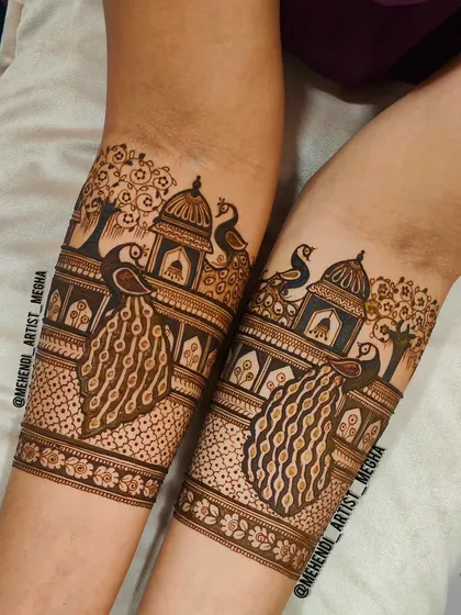 This design captures a scenic view with peacocks perched near a traditional palace and trees. It’s like wearing a beautiful painting that tells a story of heritage and romance.