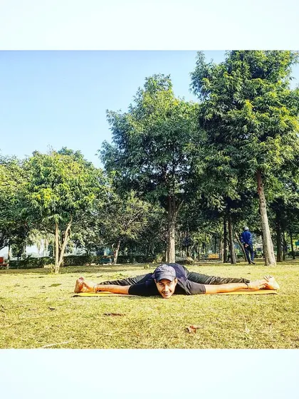 Our co-founder Nishant Sir performing a full split (Samakonasana) in the park, surrounded by the tranquility of nature.
