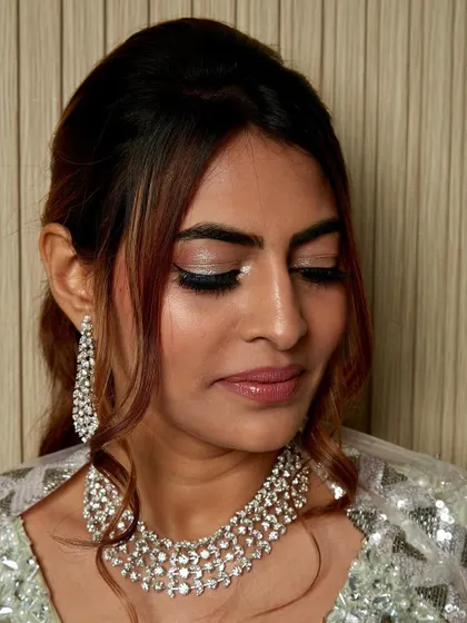 A close-up on the eyes for this shimmering look. I used a brilliant silver pigment on the lids, paired with dramatic lashes to make her eyes the center of attention.