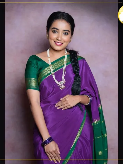 Here I am, modeling a traditional look myself. This features a classic braided hairstyle and makeup with a simple winged liner and a natural lip, perfect for a festive occasion in a silk saree.